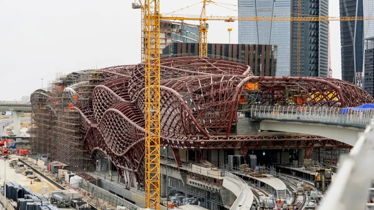 Large metro station under construction with two cranes pictured